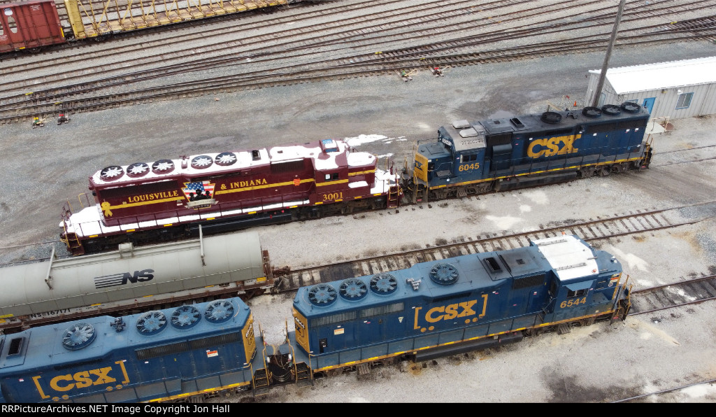 In transit back home and covered in snow, LIRC 3001 sits in the Mickey Mouse at Wyoming Yard